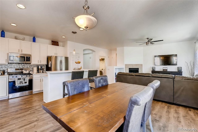 dining area featuring light hardwood / wood-style flooring and ceiling fan