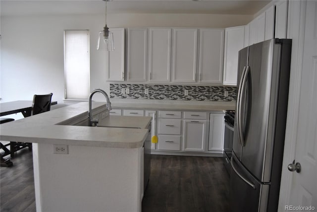 kitchen with pendant lighting, backsplash, dark hardwood / wood-style flooring, white cabinetry, and stainless steel appliances