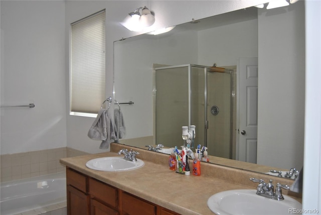 bathroom with vanity and shower with separate bathtub