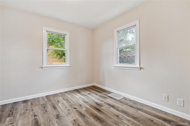 spare room with light wood-type flooring