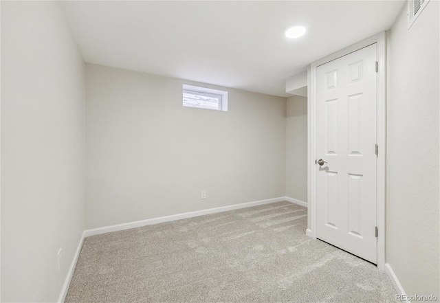 basement featuring light carpet