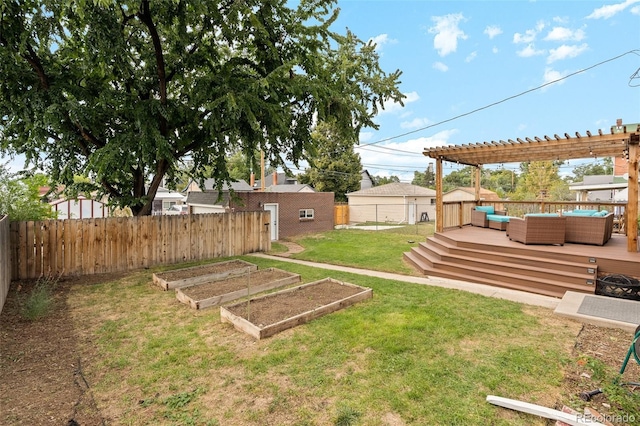 view of yard with a deck, an outbuilding, fence, an outdoor living space, and a garden