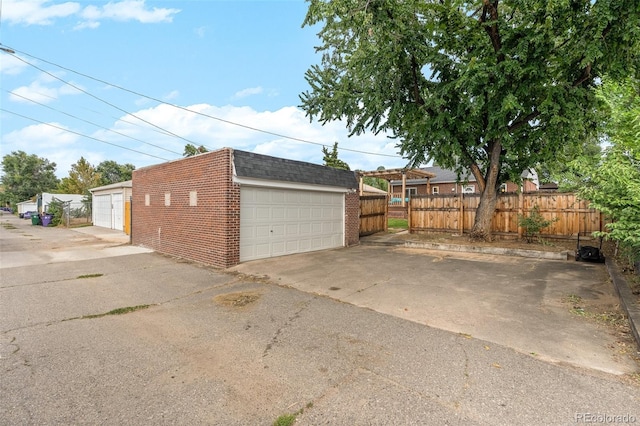 detached garage featuring fence