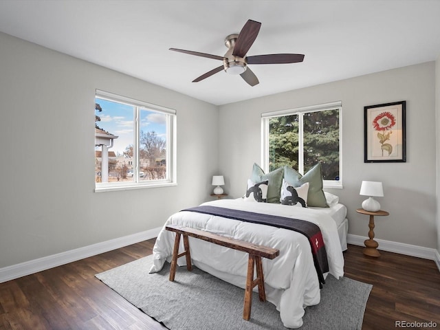 bedroom featuring wood finished floors, a ceiling fan, and baseboards