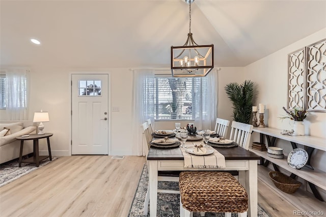 8985 Lander St, Westminster, CO 80031 - dining room with wood finished floors, a chandelier, lofted ceiling, baseboards, and recessed lighting