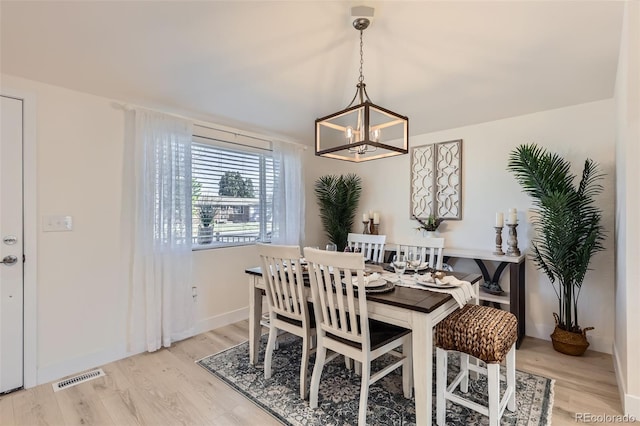 8985 Lander St, Westminster, CO 80031 - dining space featuring a chandelier, light wood-style flooring, and baseboards