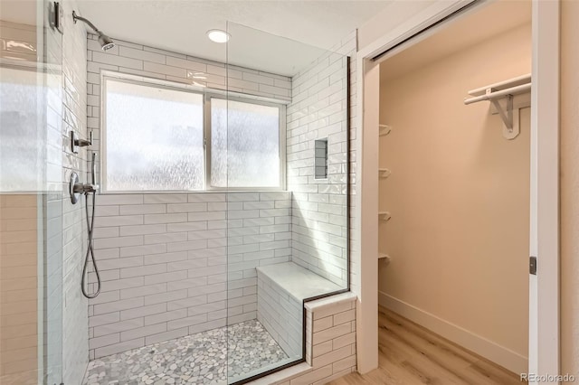 8985 Lander St, Westminster, CO 80031 - bathroom with a shower stall, wood finished floors, and baseboards