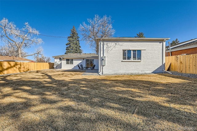 8985 Lander St, Westminster, CO 80031 - back of property featuring brick siding and a patio area