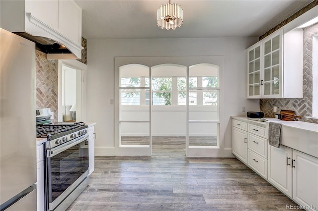4818 Bryant St, Denver, CO 80221 - kitchen with stainless steel appliances, custom exhaust hood, backsplash, and light wood finished floors