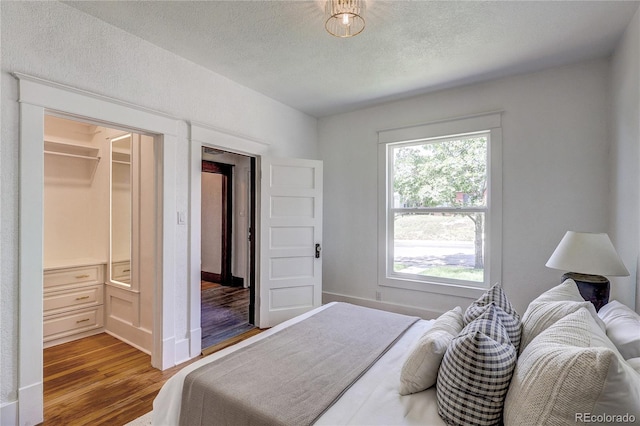 4818 Bryant St, Denver, CO 80221 - bedroom featuring wood finished floors and a textured ceiling