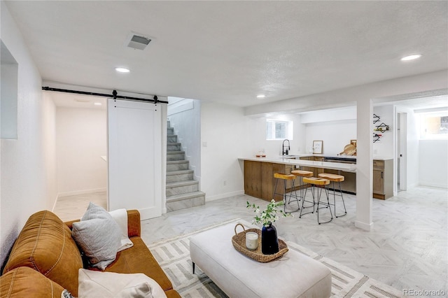 4818 Bryant St, Denver, CO 80221 - living area featuring a barn door, recessed lighting, stairway, and healthy amount of natural light