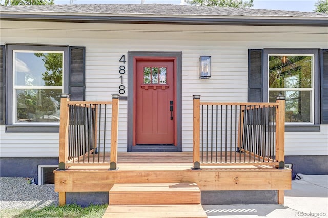 4818 Bryant St, Denver, CO 80221 - view of exterior entry featuring a porch and a shingled roof