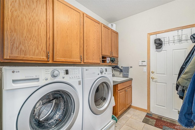 5289 Fairfield Cir, Castle Rock, CO 80104 - laundry area featuring cabinet space, independent washer and dryer, light tile patterned floors, and a textured ceiling