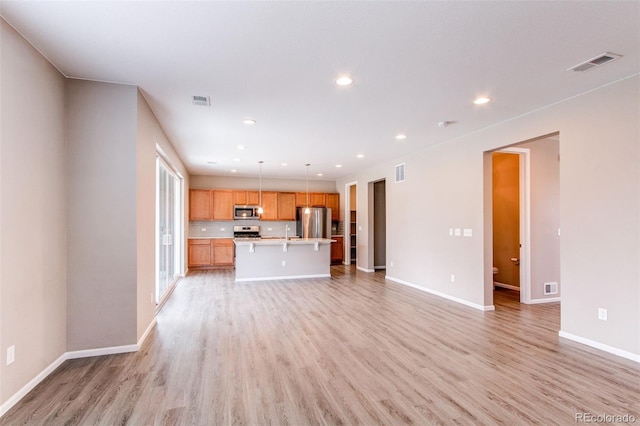 unfurnished living room featuring visible vents, baseboards, recessed lighting, and light wood-style floors