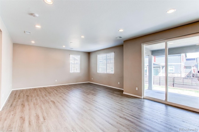 unfurnished room featuring recessed lighting, visible vents, and wood finished floors