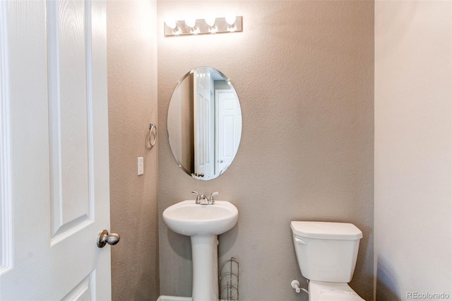 half bath featuring toilet