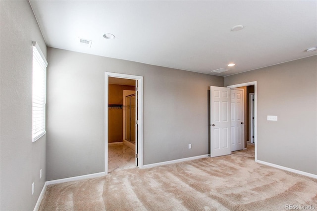 unfurnished bedroom with visible vents, baseboards, recessed lighting, and light colored carpet