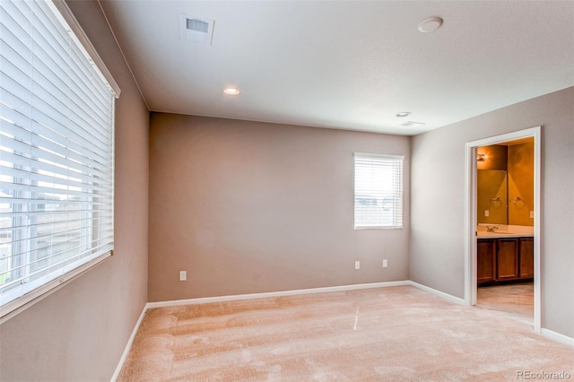 unfurnished room featuring visible vents, baseboards, recessed lighting, and light colored carpet