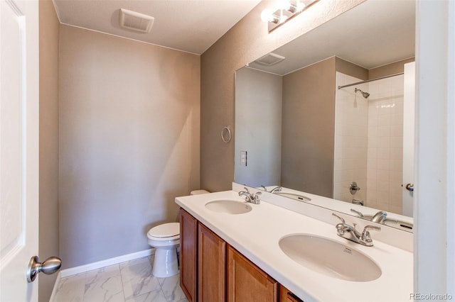 bathroom featuring toilet, a sink, visible vents, and a shower