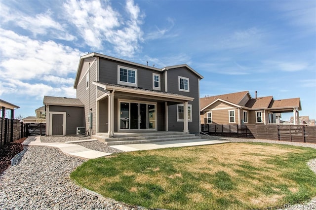 rear view of house with a yard, central air condition unit, and a fenced backyard