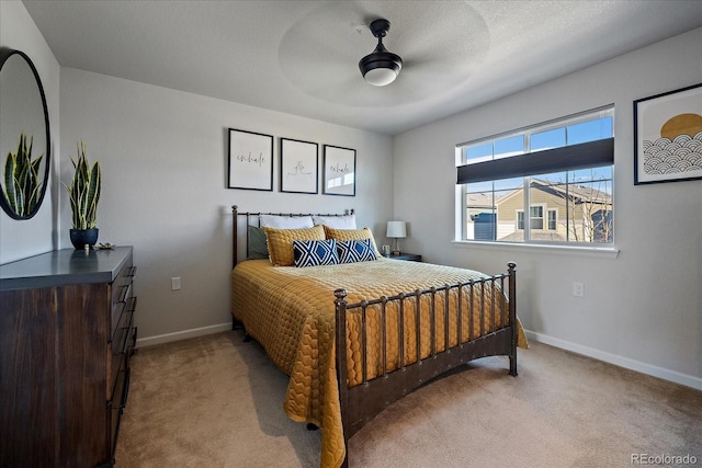 bedroom with light carpet, ceiling fan, a textured ceiling, and baseboards