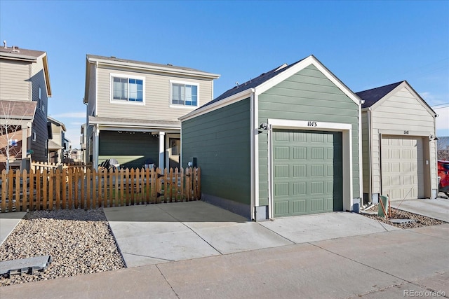 traditional-style home featuring a garage and fence