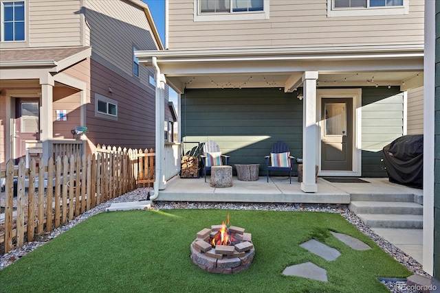 exterior space featuring a lawn, a patio area, and fence