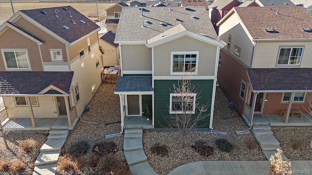 exterior space with a shingled roof, a residential view, and a patio area