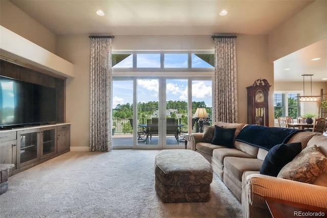 17275 Gwilym Ct, Monument, CO 80132 - living room with carpet flooring, recessed lighting, a high ceiling, french doors, and baseboards