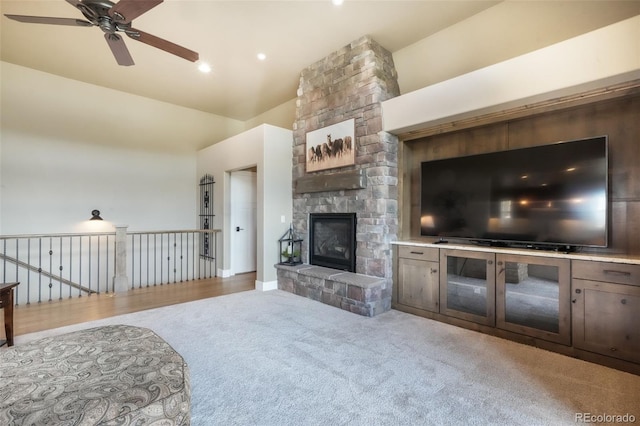 17275 Gwilym Ct, Monument, CO 80132 - carpeted living room with ceiling fan, a stone fireplace, and high vaulted ceiling