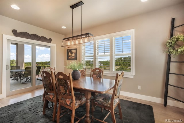 17275 Gwilym Ct, Monument, CO 80132 - dining area with healthy amount of natural light, light wood finished floors, baseboards, and recessed lighting