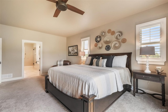 17275 Gwilym Ct, Monument, CO 80132 - bedroom featuring light colored carpet, ensuite bath, ceiling fan, and baseboards