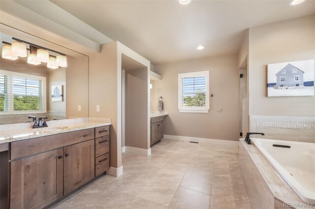 17275 Gwilym Ct, Monument, CO 80132 - full bathroom with vanity, a garden tub, baseboards, and recessed lighting