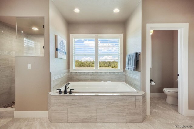 17275 Gwilym Ct, Monument, CO 80132 - full bathroom with a garden tub, a walk in shower, toilet, baseboards, and tile patterned flooring