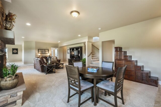 17275 Gwilym Ct, Monument, CO 80132 - dining space featuring stairs, light colored carpet, baseboards, and recessed lighting