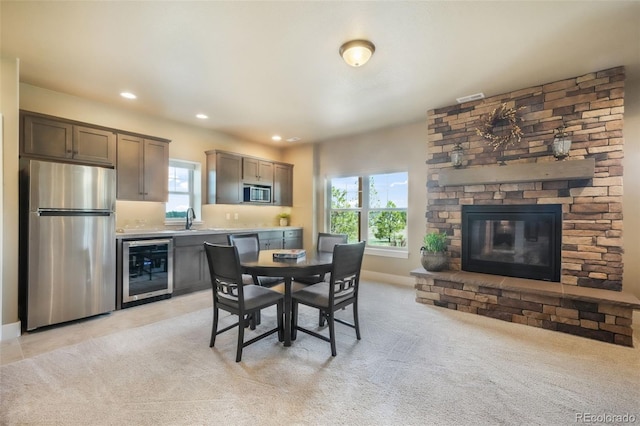17275 Gwilym Ct, Monument, CO 80132 - dining area featuring beverage cooler, healthy amount of natural light, baseboards, recessed lighting, and a fireplace