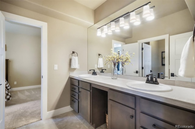 17275 Gwilym Ct, Monument, CO 80132 - full bath with double vanity, tile patterned floors, and baseboards