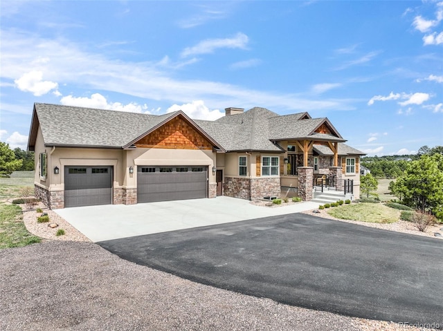 17275 Gwilym Ct, Monument, CO 80132 - craftsman-style house featuring stone siding, an attached garage, driveway, roof with shingles, and a chimney