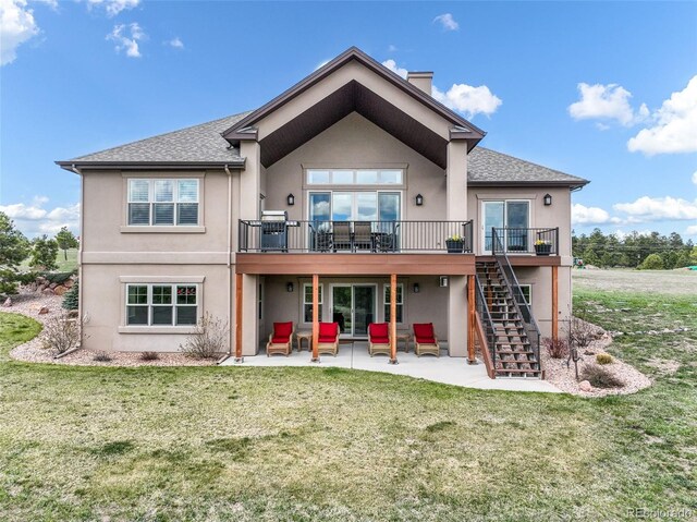17275 Gwilym Ct, Monument, CO 80132 - rear view of property with stucco siding, a patio, stairway, a wooden deck, and a lawn