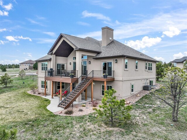 17275 Gwilym Ct, Monument, CO 80132 - rear view of house featuring stucco siding, a shingled roof, stairway, a deck, and a chimney