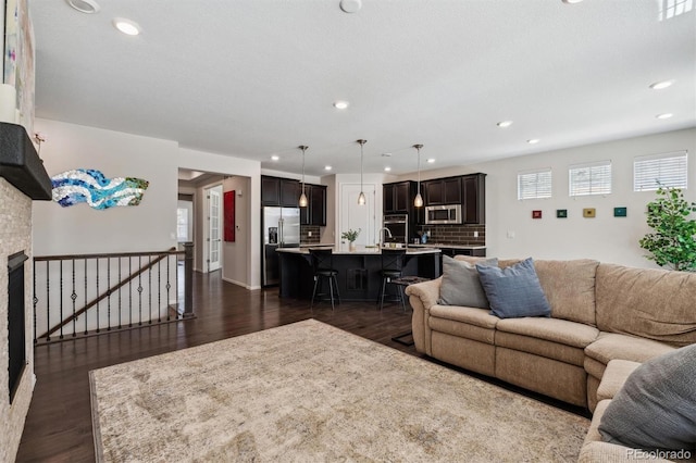 living area featuring dark wood finished floors and recessed lighting