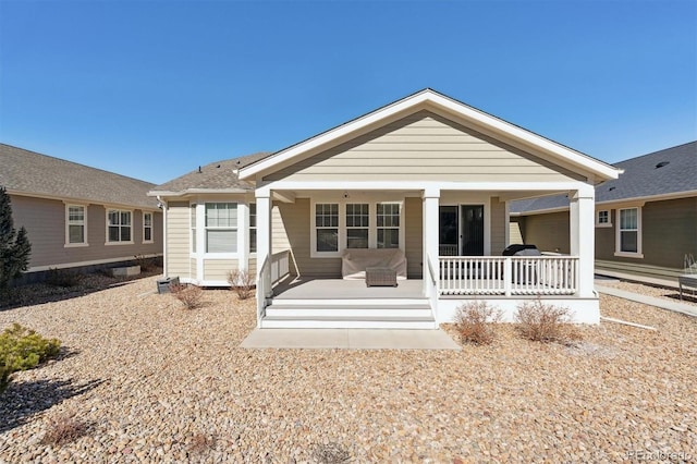 back of house featuring a porch