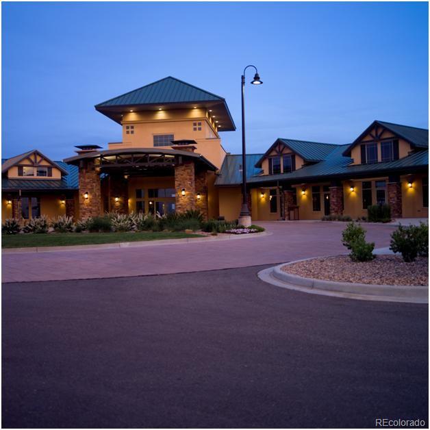 property at dusk featuring curved driveway