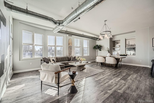 living room with hardwood / wood-style flooring and a chandelier