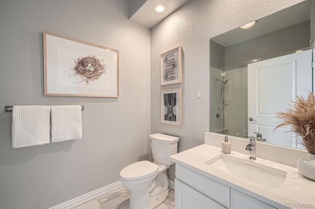 bathroom featuring walk in shower, vanity, and toilet