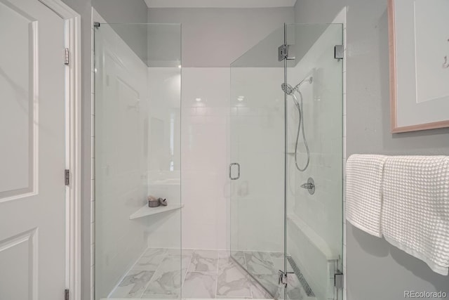 bathroom featuring a shower with shower door