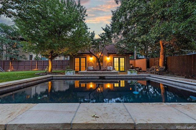 235 Eudora St, Denver, CO 80220 - pool at dusk with french doors, a fenced backyard, and a patio