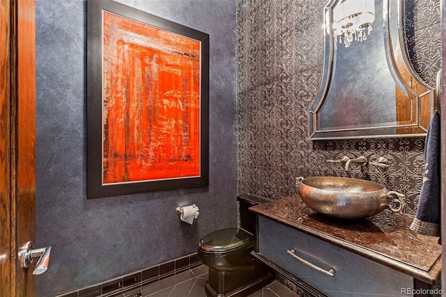 235 Eudora St, Denver, CO 80220 - half bathroom featuring tile patterned flooring, vanity, and wallpapered walls