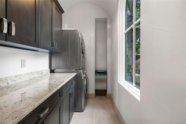 235 Eudora St, Denver, CO 80220 - laundry area featuring cabinet space, estacked washer and dryer, and healthy amount of natural light