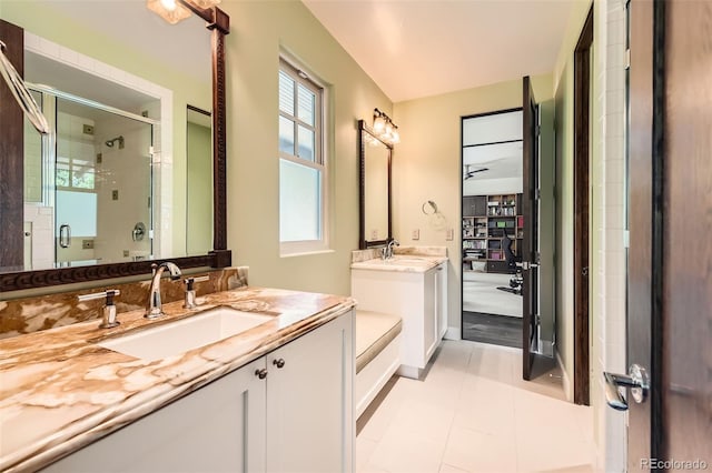 235 Eudora St, Denver, CO 80220 - bathroom featuring a stall shower, two vanities, and tile patterned flooring
